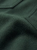 Macro shot of soft green suede texture and silver snap button detail on western shirt. The Liam by Maverick Jacket.