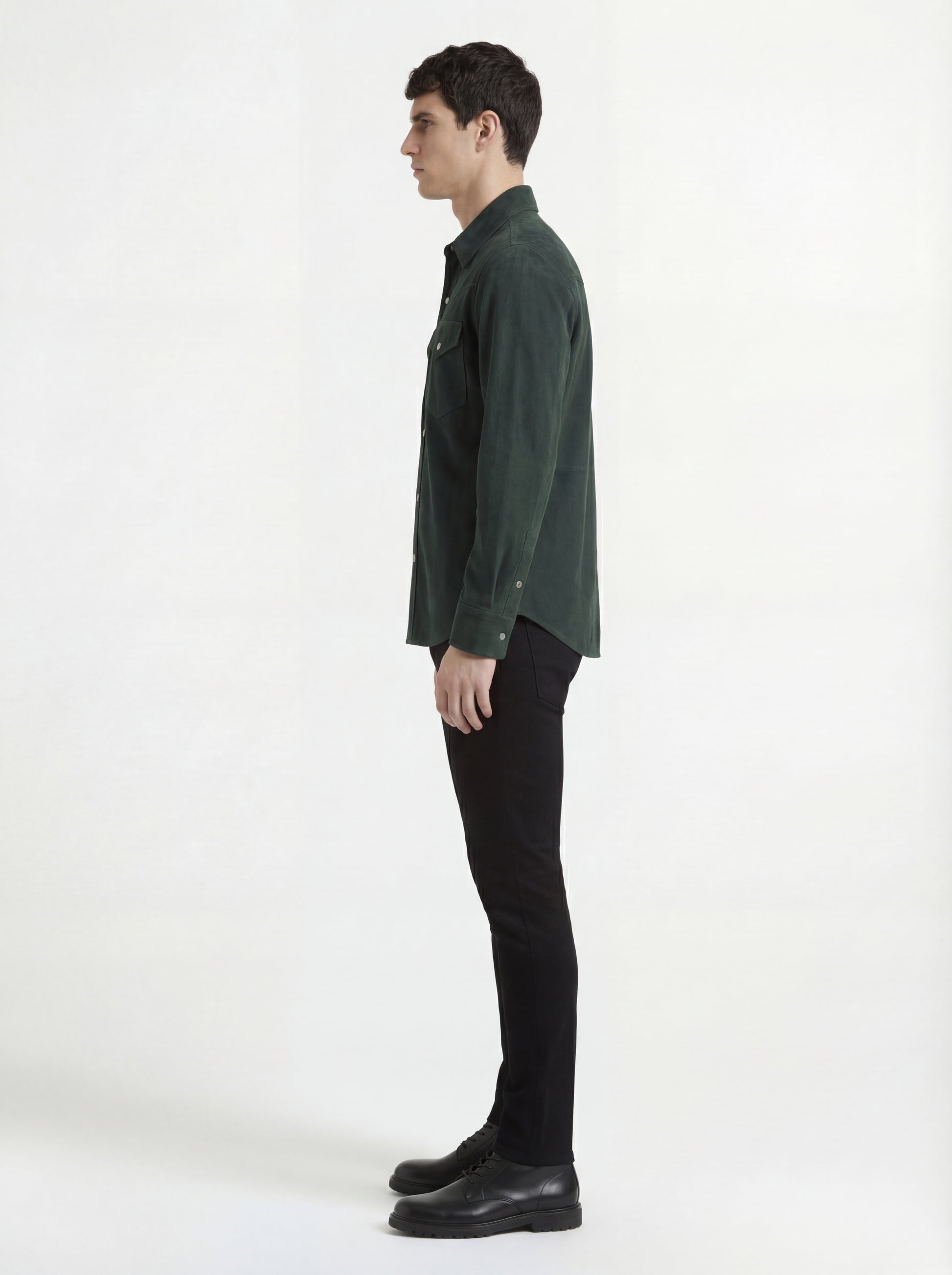 Side profile of Maverick Liam suede western shirt showing long sleeve cuff structure and straight silhouette. Maverick Jacket.