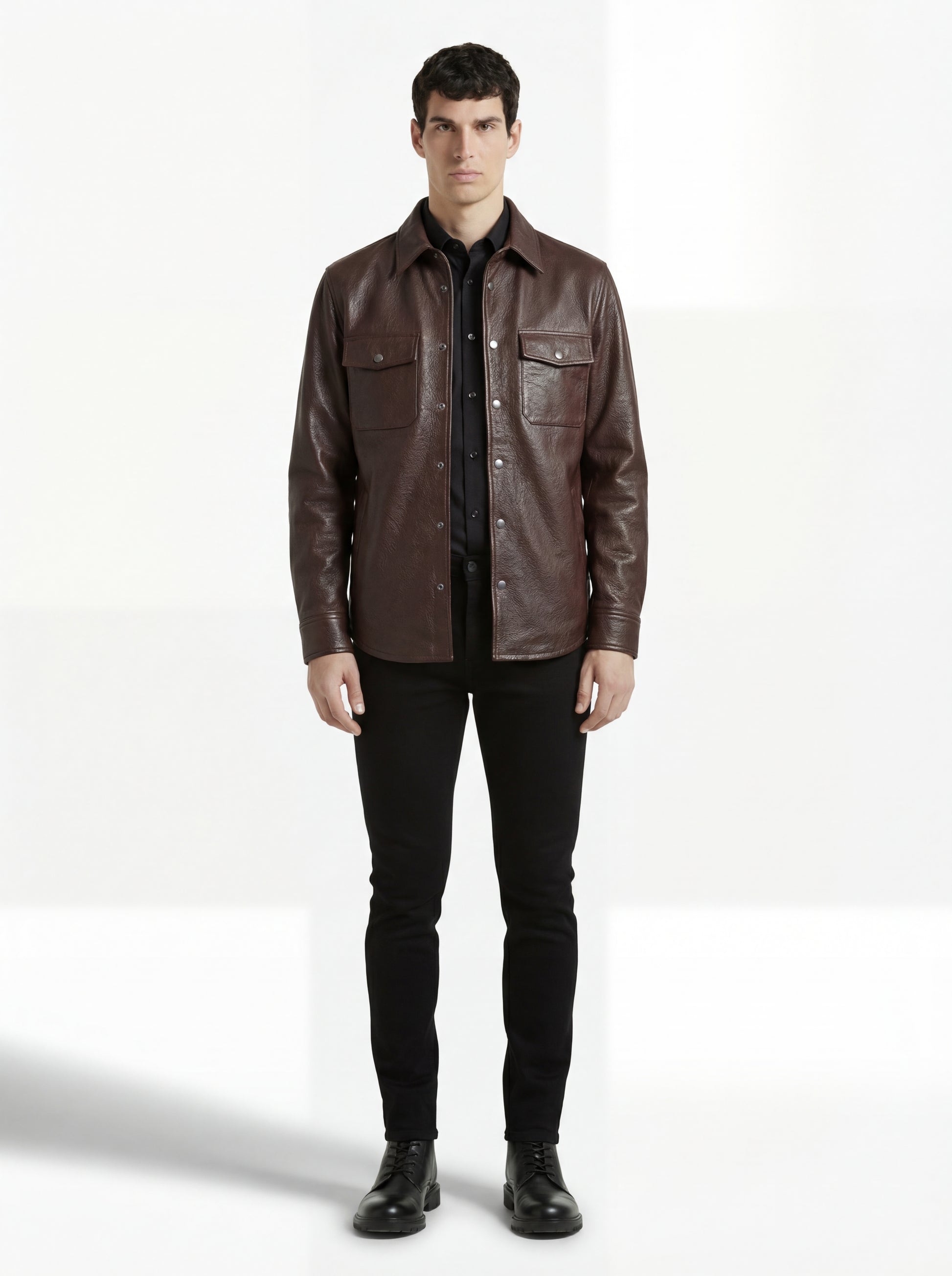 Male model wearing Maverick Garrison dark brown leather overshirt, regular fit, styled with black skinny jeans. Maverick Jacket.