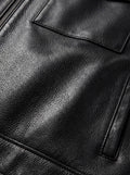 Macro shot of grained black leather texture and chest flap pocket stitching on zip-front shirt. The Spencer by Maverick Jacket.