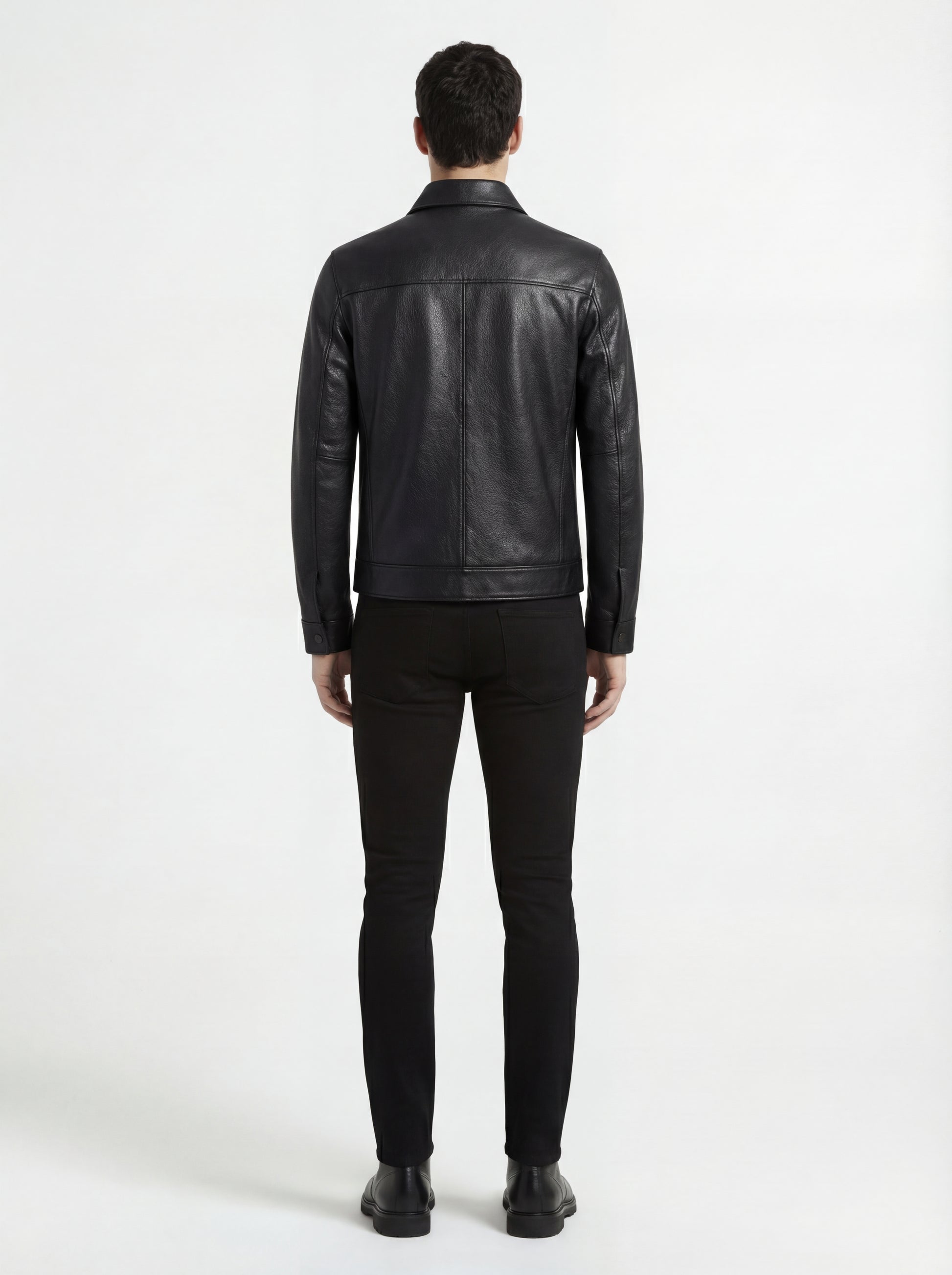 Rear view of male model wearing Maverick Spencer leather zip-front shirt showing tailored shoulder fit and straight hem styling. Maverick Jacket.
