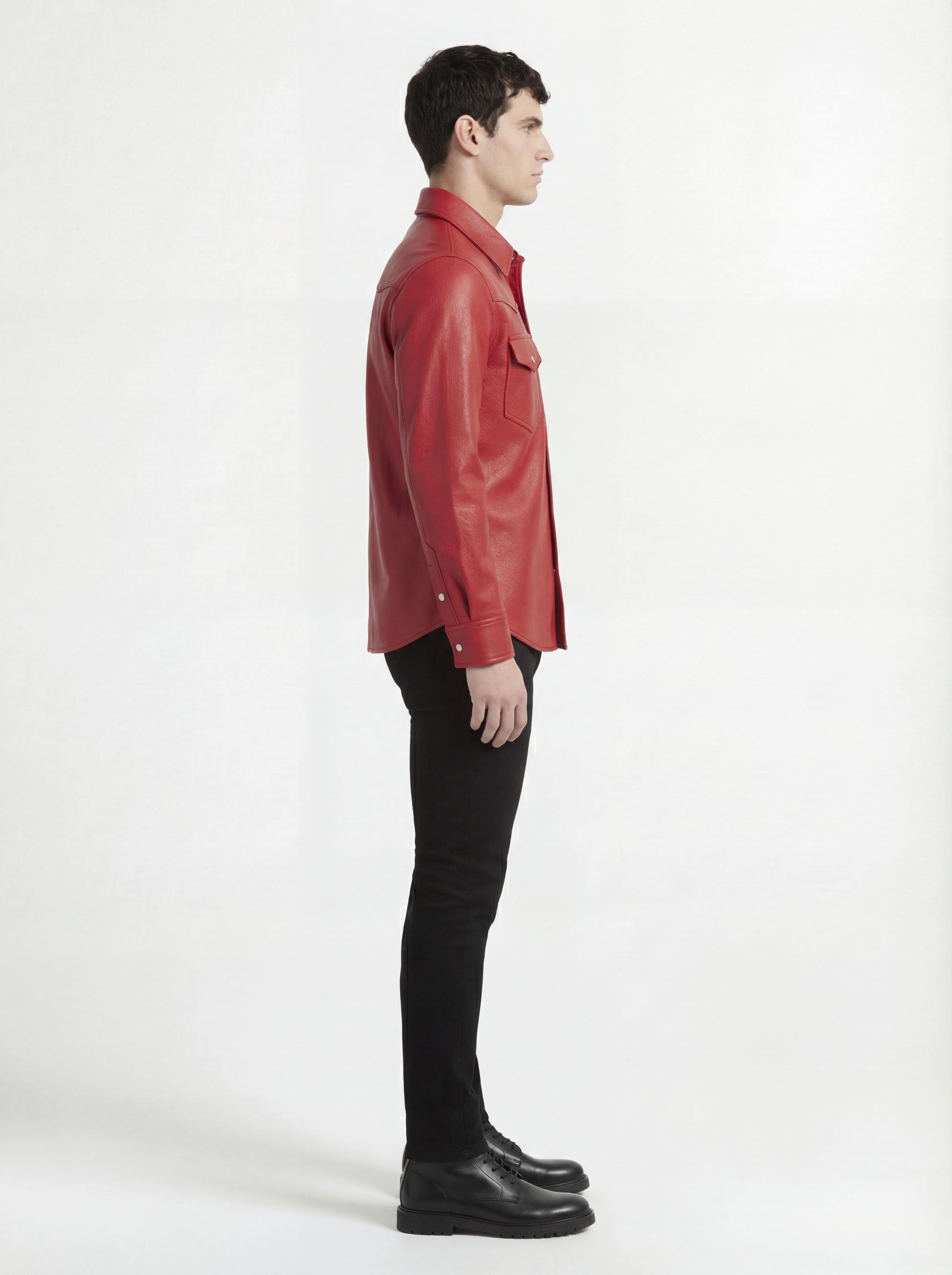 Side profile of Maverick Griffin red leather western shirt showing long sleeve cuff structure and straight silhouette. Maverick Jacket.
