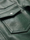 Macro shot of grained green leather texture and silver snap button detail on western shirt. The Cillian by Maverick Jacket.