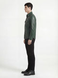 Side profile of Maverick Cillian green leather western shirt showing long sleeve cuff structure and straight silhouette. Maverick Jacket.