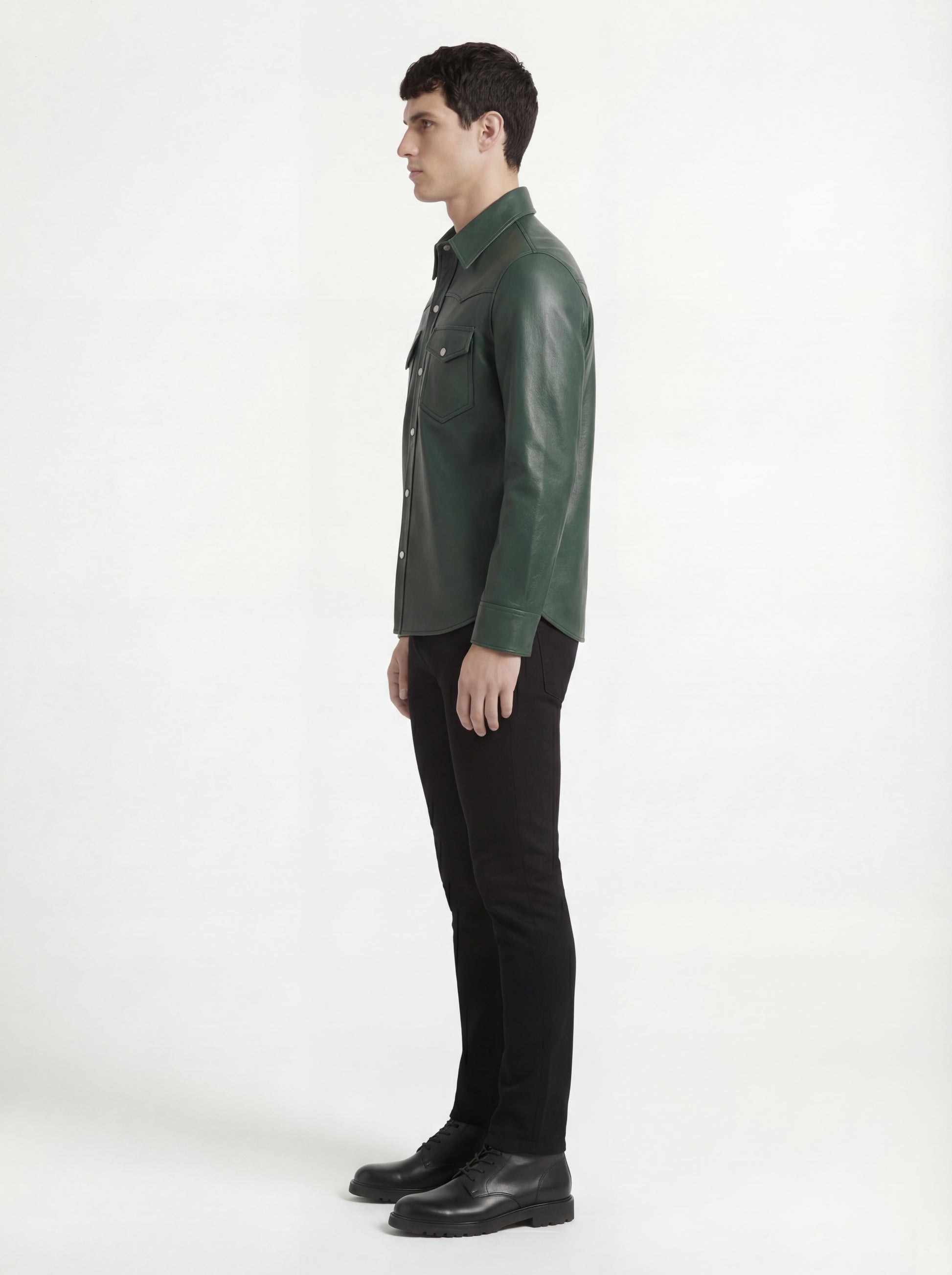 Side profile of Maverick Cillian green leather western shirt showing long sleeve cuff structure and straight silhouette. Maverick Jacket.