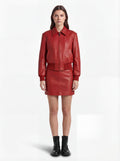 Female model wearing Maverick Isla leather bomber jacket, relaxed fit, styled with Maverick Orla red leather mini skirt. Maverick Jacket.