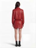 Rear view of female model wearing Maverick Isla leather bomber jacket showing structured shoulder fit and elasticated hem styling. Maverick Jacket.