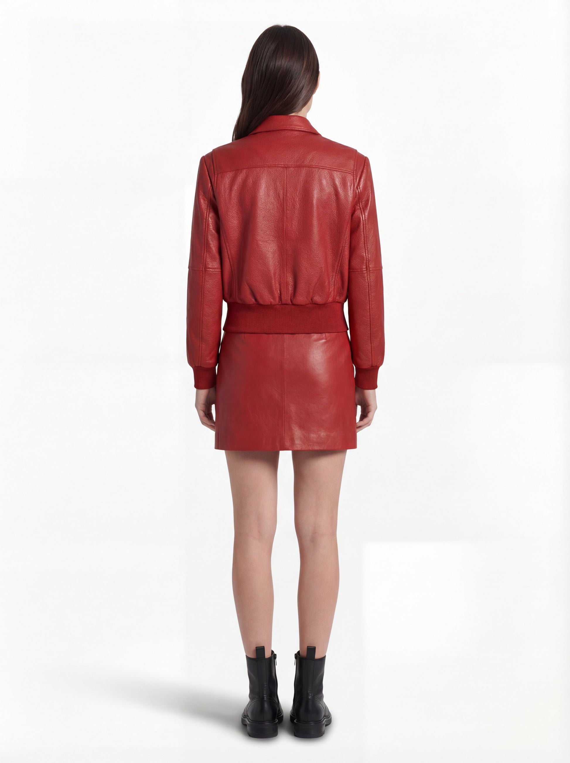 Rear view of female model wearing Maverick Isla leather bomber jacket showing structured shoulder fit and elasticated hem styling. Maverick Jacket.