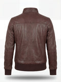Rear view of brown leather bomber jacket showing ribbed waist hem and structured yoke paneling. The Sienna by Maverick Jacket.