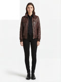 Female model wearing Maverick Sienna brown bomber jacket, regular fit, styled with black button-down shirt and black skinny jeans. Maverick Jacket.