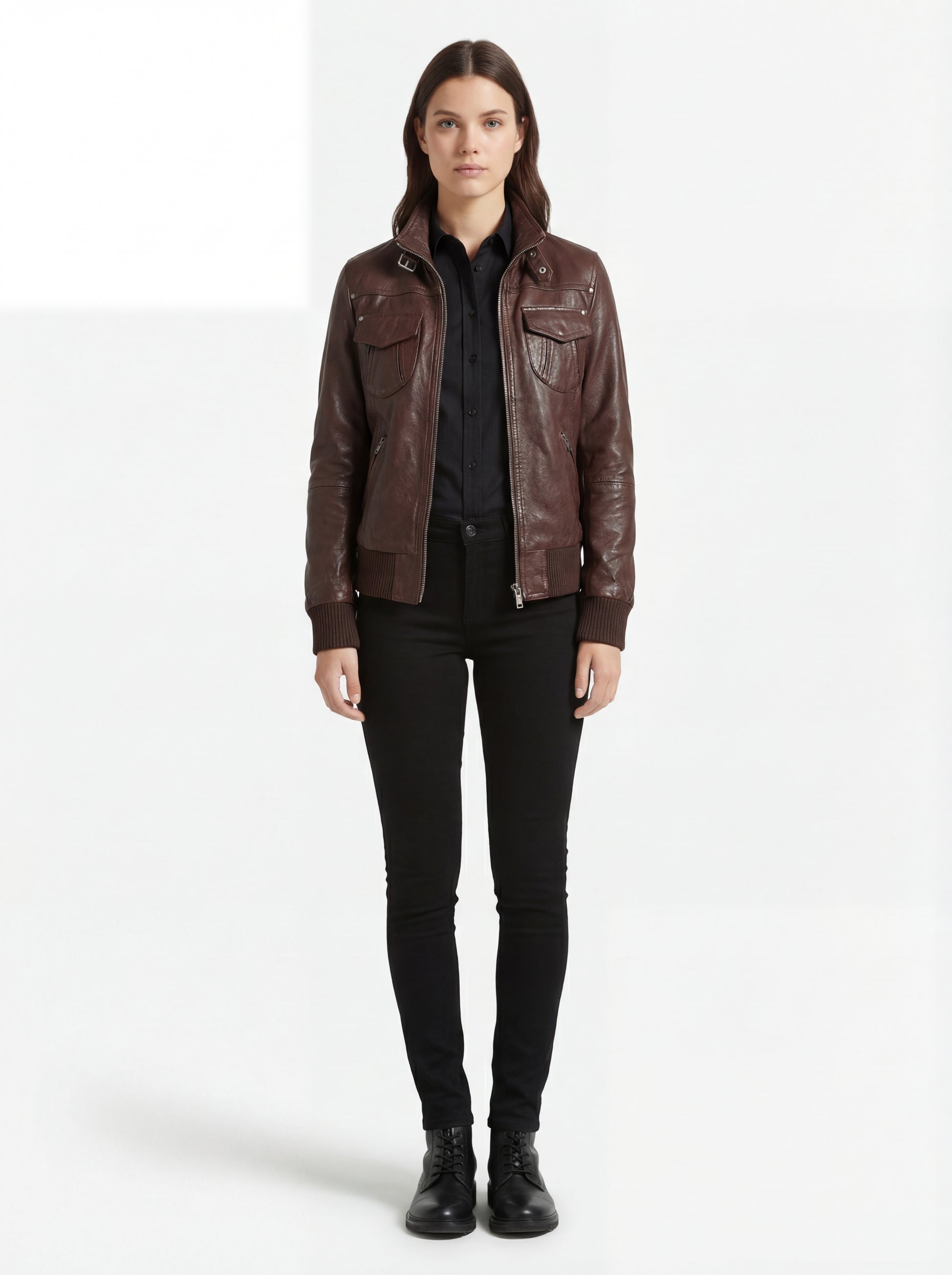 Female model wearing Maverick Sienna brown bomber jacket, regular fit, styled with black button-down shirt and black skinny jeans. Maverick Jacket.