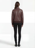 Rear view of female model wearing Maverick Sienna brown bomber jacket showing structured fit and ribbed hem styling. Maverick Jacket.