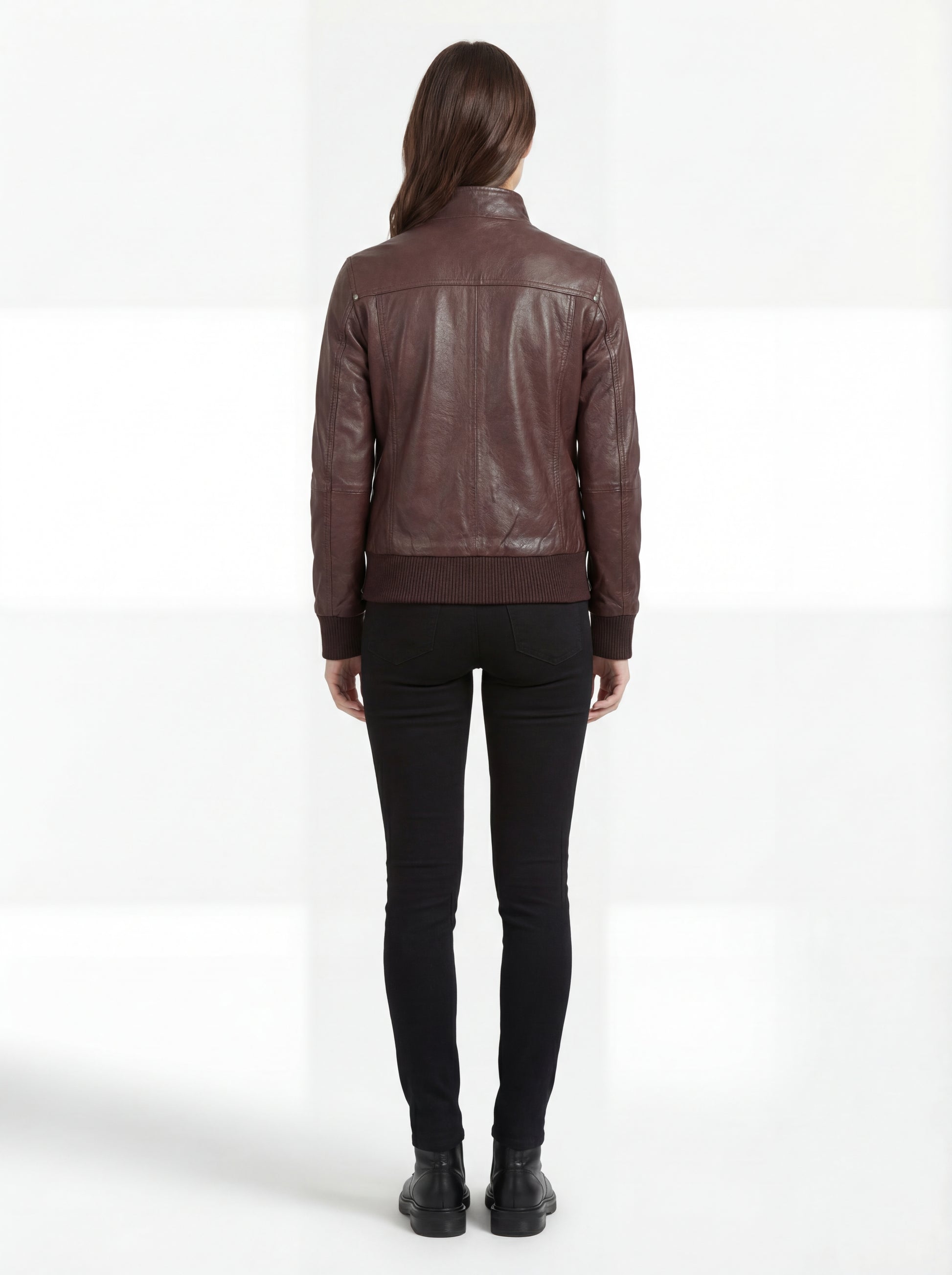 Rear view of female model wearing Maverick Sienna brown bomber jacket showing structured fit and ribbed hem styling. Maverick Jacket.