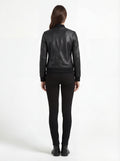 Rear view of female model wearing Maverick Roxy leather bomber showing fitted back silhouette and ribbed hem styling. Maverick Jacket.