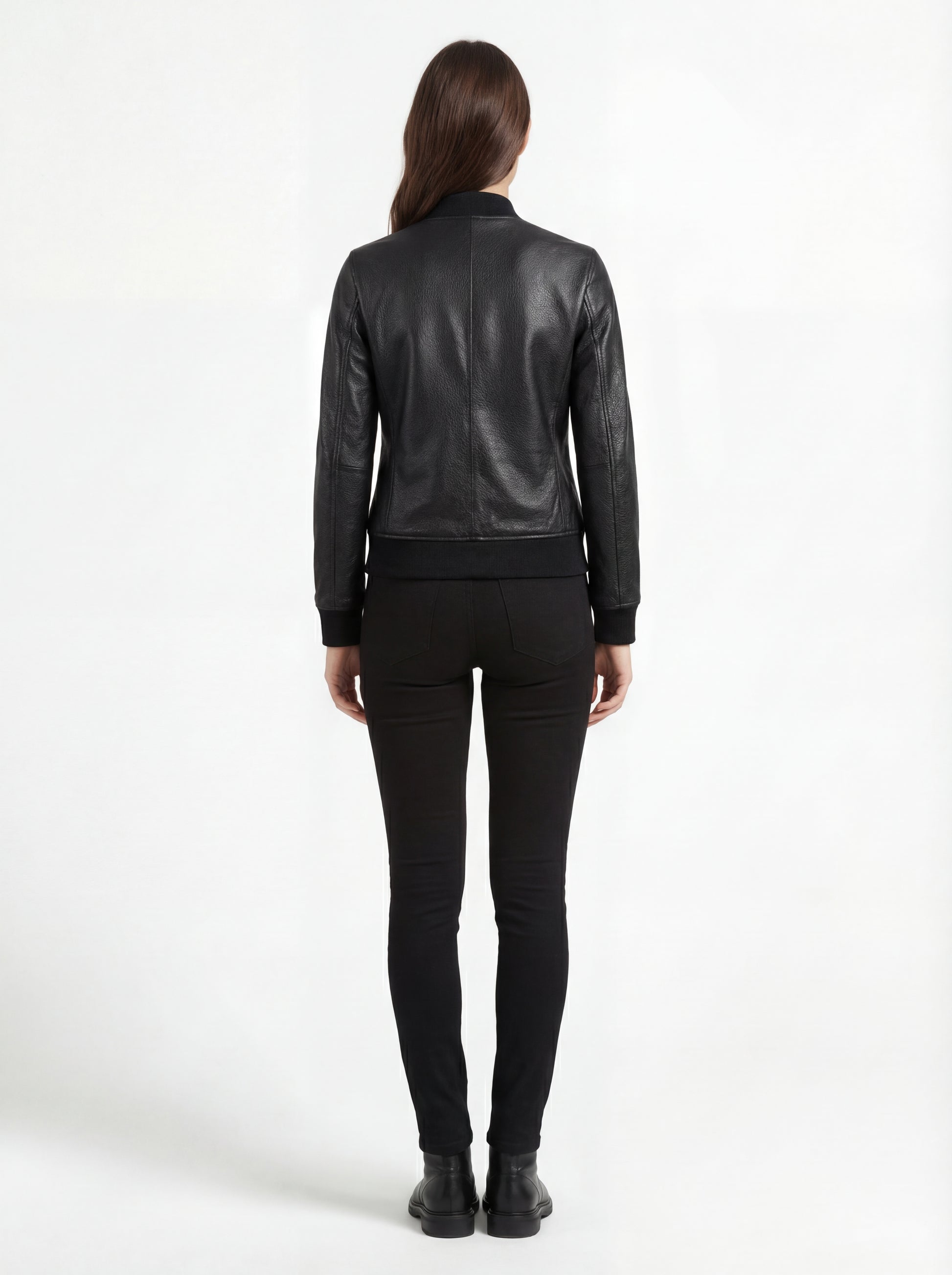 Rear view of female model wearing Maverick Roxy leather bomber showing fitted back silhouette and ribbed hem styling. Maverick Jacket.
