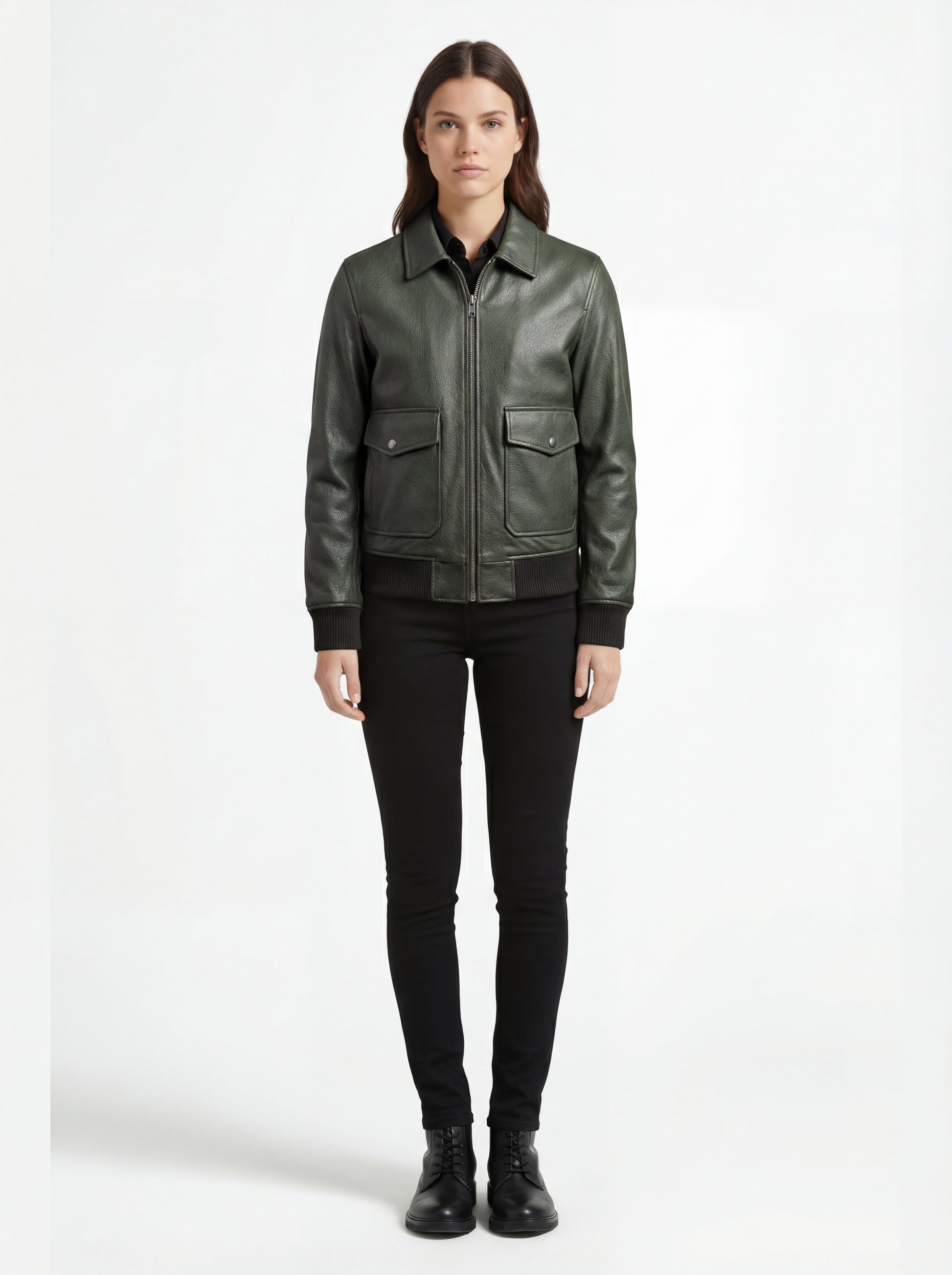 Female model wearing Maverick Verdant green pebbled bomber, regular fit, styled with black button-down shirt and black skinny jeans. Maverick Jacket.