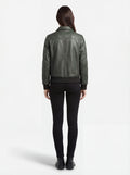 Rear view of female model wearing Maverick Verdant green pebbled bomber showing structured shoulder fit and ribbed hem styling. Maverick Jacket.