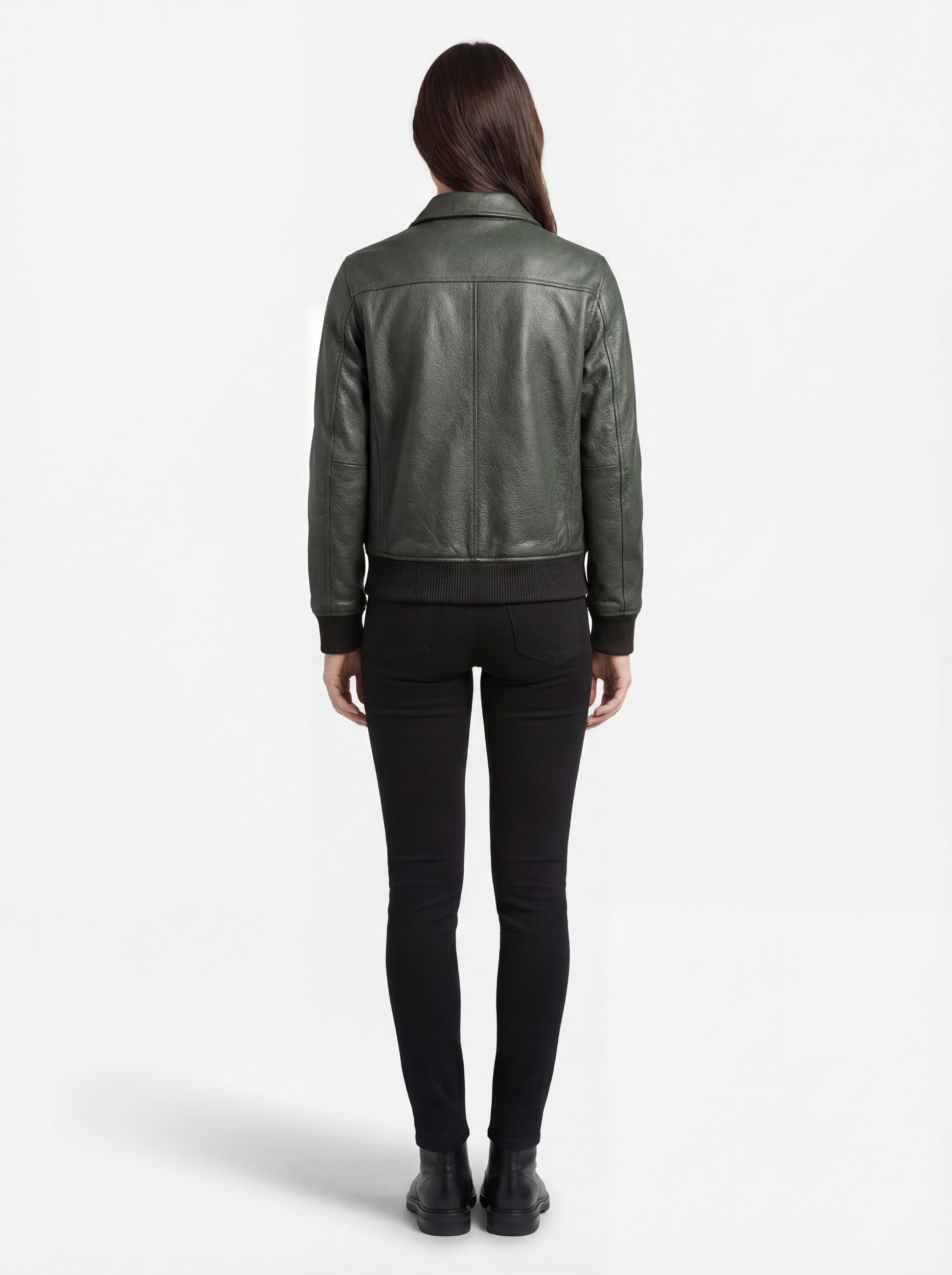 Rear view of female model wearing Maverick Verdant green pebbled bomber showing structured shoulder fit and ribbed hem styling. Maverick Jacket.