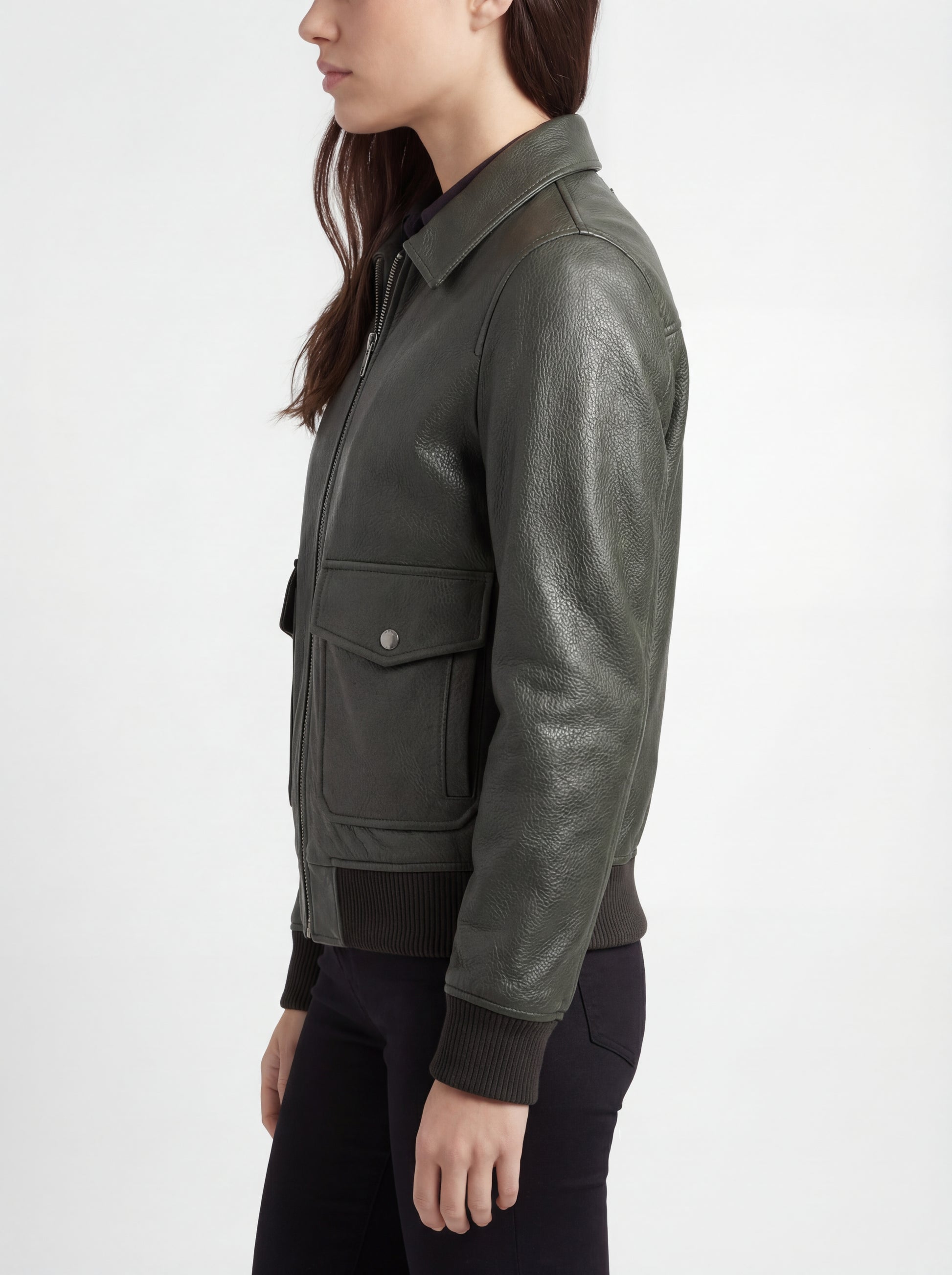 Side profile of Maverick Verdant green pebbled bomber showing ribbed cuffs and straight silhouette. Maverick Jacket.