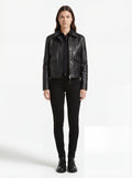 Female model wearing Maverick Matrix black trucker jacket, regular fit, styled with black button-down shirt and black skinny jeans. Maverick Jacket.