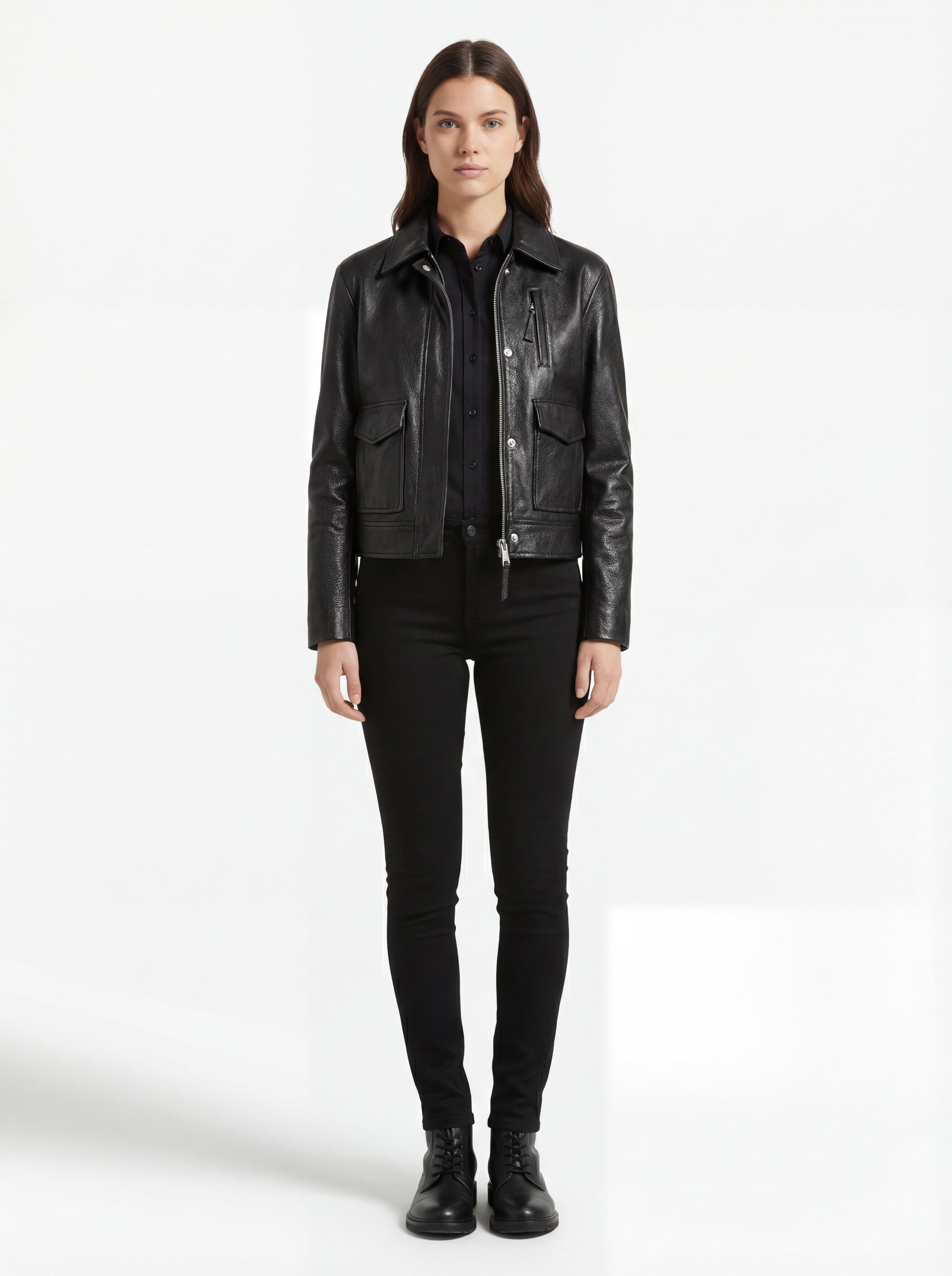 Female model wearing Maverick Matrix black trucker jacket, regular fit, styled with black button-down shirt and black skinny jeans. Maverick Jacket.