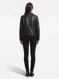 Rear view of female model wearing Maverick Matrix black trucker jacket showing structured shoulder fit and straight hem styling. Maverick Jacket.