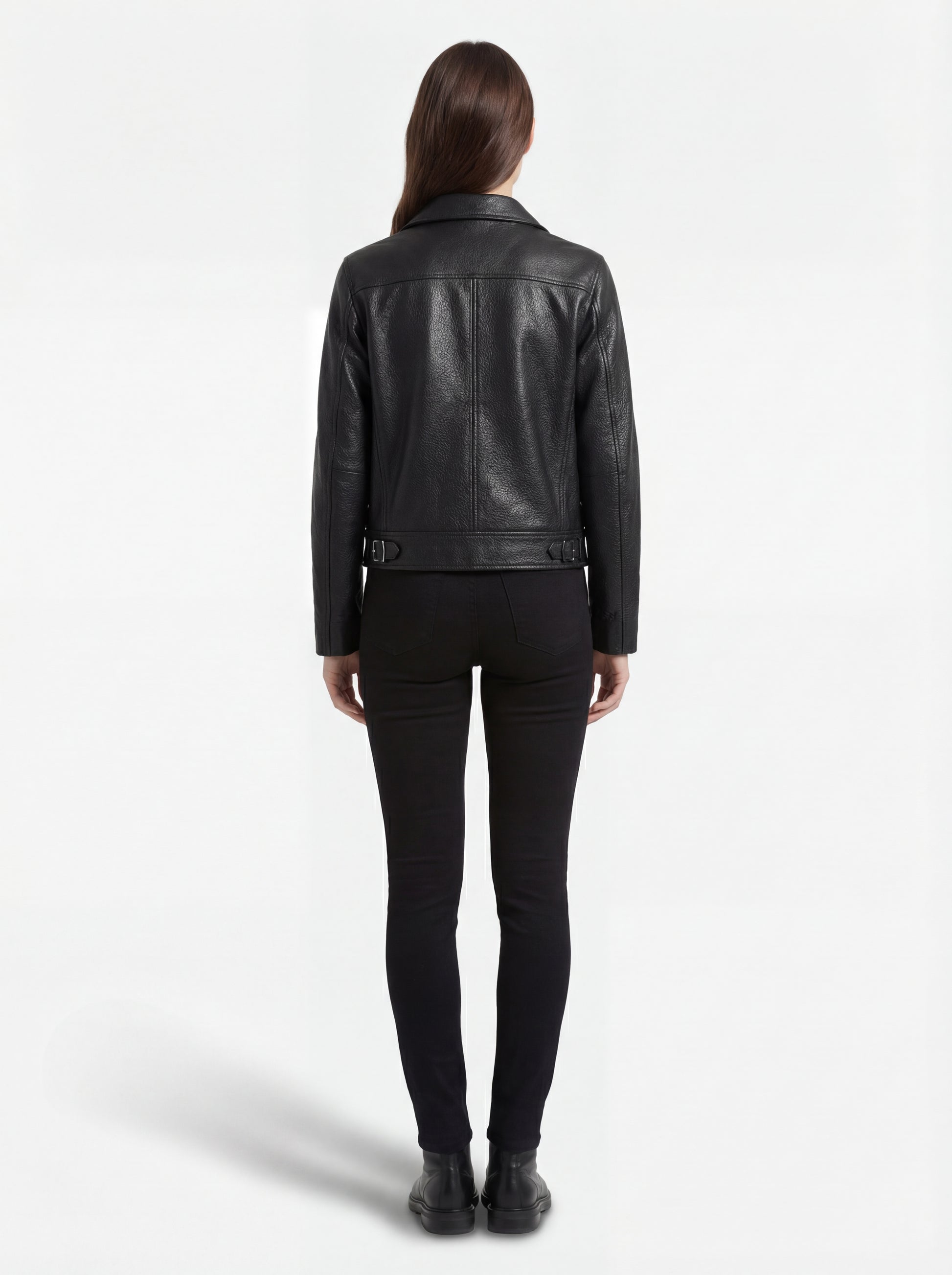 Rear view of female model wearing Maverick Matrix black trucker jacket showing structured shoulder fit and straight hem styling. Maverick Jacket.