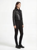 Side profile of Maverick Raven black biker jacket showing zippered sleeve cuffs and slim cropped silhouette. Maverick Jacket.