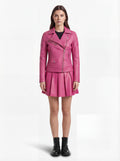 Female model wearing Maverick Cleo leather biker jacket, slim fit, styled with Maverick Poppy fuchsia pleated leather skirt. Maverick Jacket.
