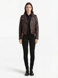 Female model wearing Maverick Zephyr distressed brown biker jacket, regular fit, styled with black button-down shirt and black skinny jeans. Maverick Jacket.