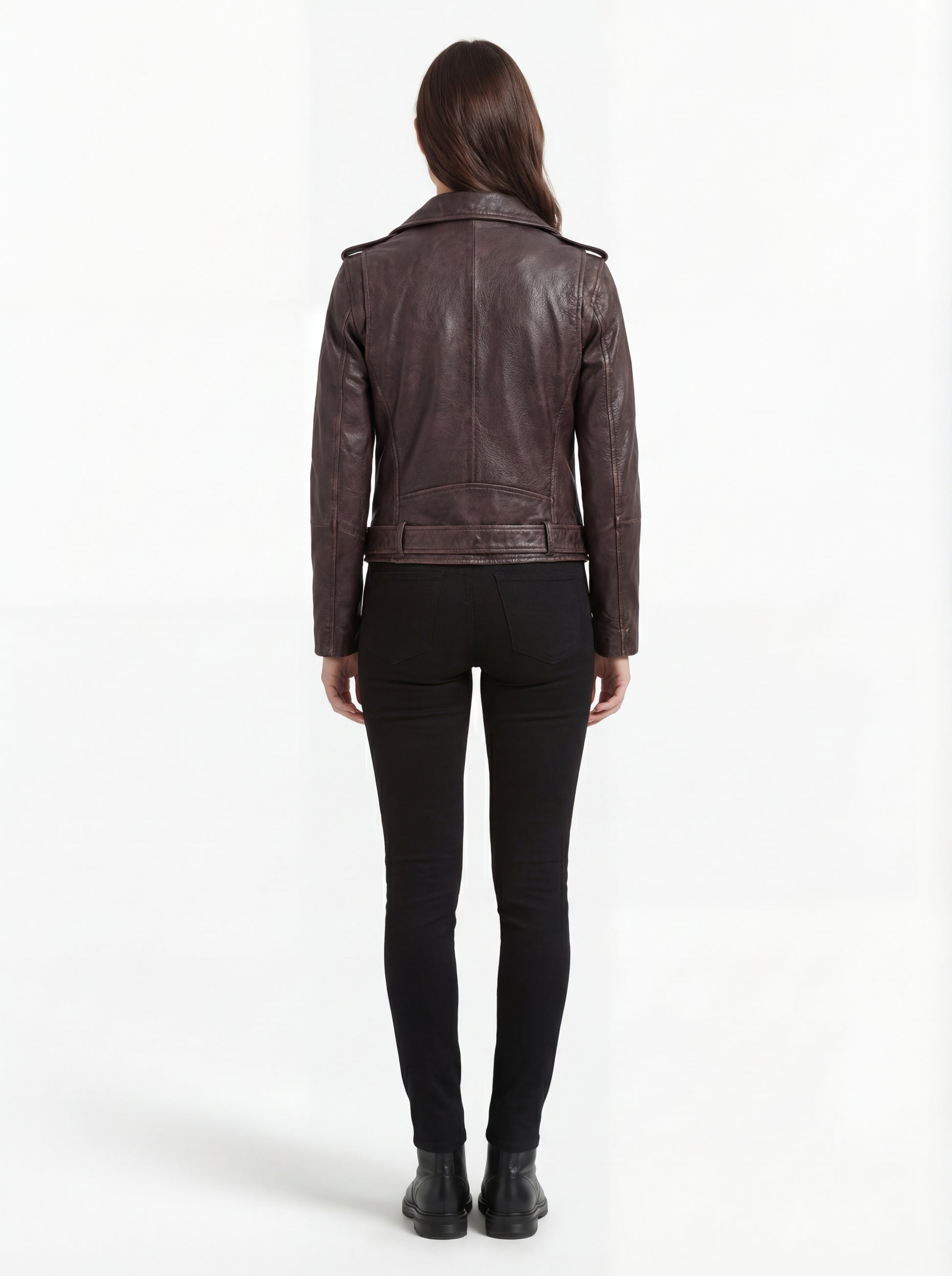 Rear view of female model wearing Maverick Zephyr distressed brown biker jacket showing structured shoulder fit and belted waist styling. Maverick Jacket.