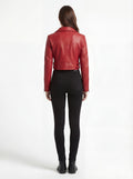 Rear view of female model wearing Maverick Vixen red biker jacket showing structured shoulder fit and cropped hem styling. Maverick Jacket.