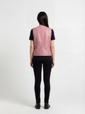 Rear view of female model wearing Maverick Belle leather vest showing structured shoulder fit and vertical seam detailing. Maverick Jacket.