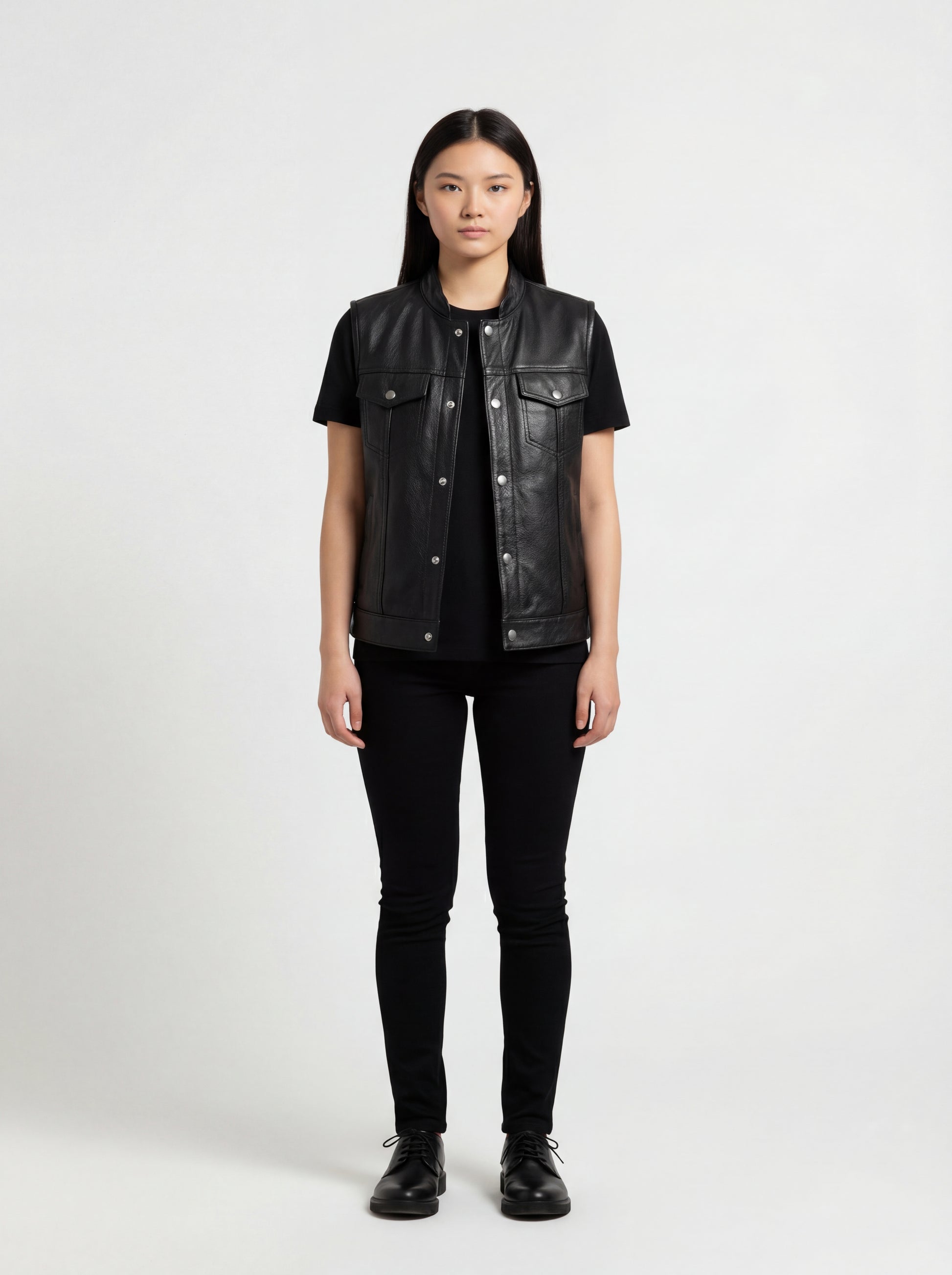 Female model wearing Maverick Oakley leather vest, relaxed fit, styled with black t-shirt and black skinny jeans. Maverick Jacket.