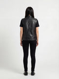 Rear view of female model wearing Maverick Oakley leather vest showing structured shoulder fit and panelled back styling. Maverick Jacket.