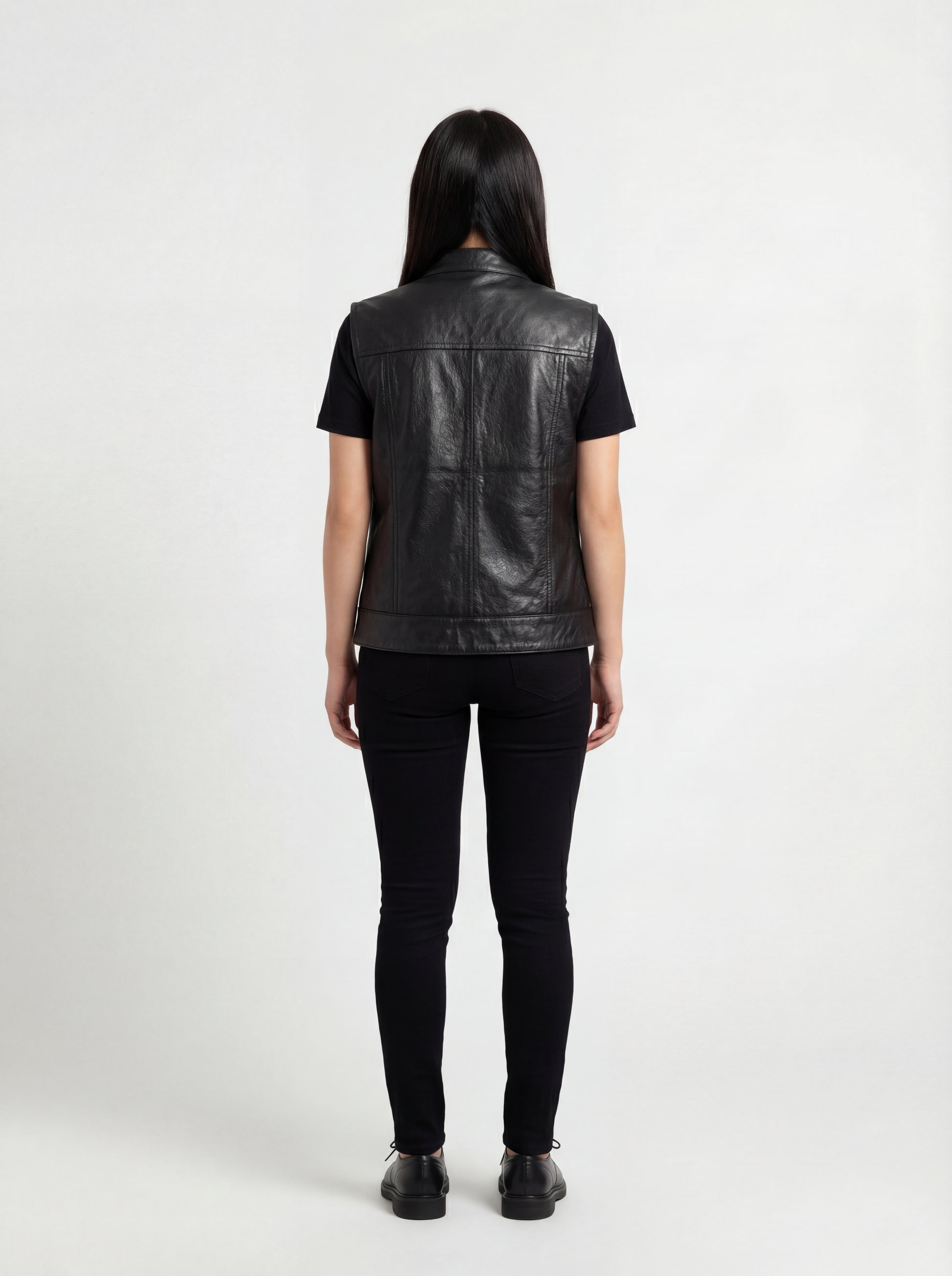 Rear view of female model wearing Maverick Oakley leather vest showing structured shoulder fit and panelled back styling. Maverick Jacket.