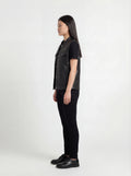 Side profile of Maverick Oakley leather vest showing sleeveless armhole cut and straight hip-length silhouette. Maverick Jacket.
