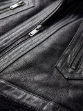Macro shot of black shearling wool texture and silver metal zipper details on vest. The Aves by Maverick Jacket.