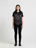 Female model wearing Maverick Aves shearling vest, slim fit, styled with black skinny jeans and basic tee. Maverick Jacket.