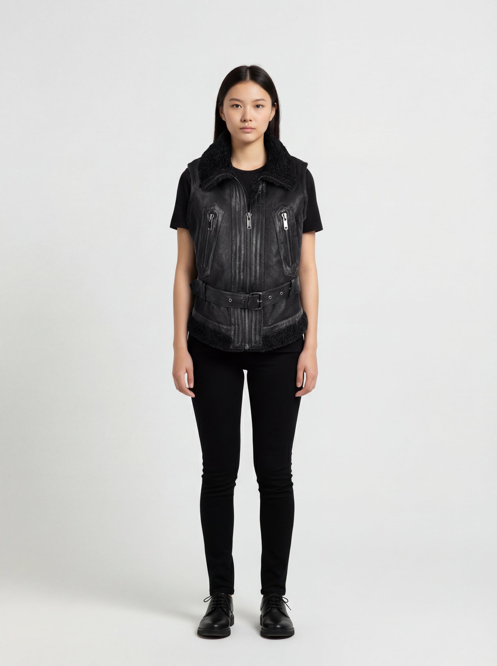 Female model wearing Maverick Aves shearling vest, slim fit, styled with black skinny jeans and basic tee. Maverick Jacket.