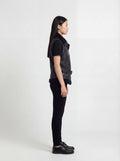 Side profile of Maverick Aves shearling vest showing sleeveless cut and belted waist adjustment. Maverick Jacket.