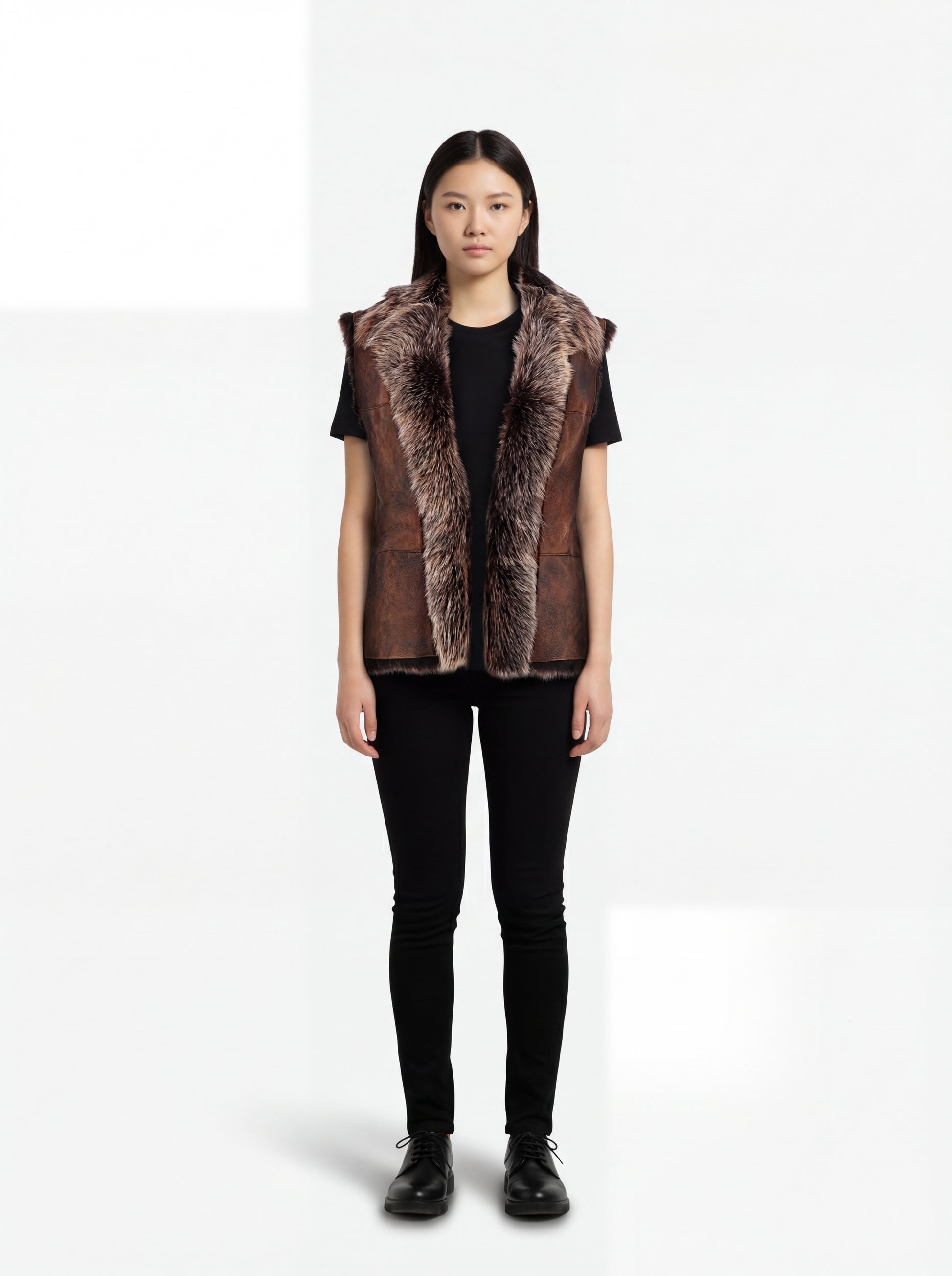 Female model wearing Maverick Freya leather vest, relaxed fit, styled with black t-shirt and black skinny jeans. Maverick Jacket.