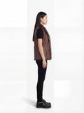 Side profile of Maverick Freya leather vest showing sleeveless armhole cut and straight hip-length silhouette. Maverick Jacket.