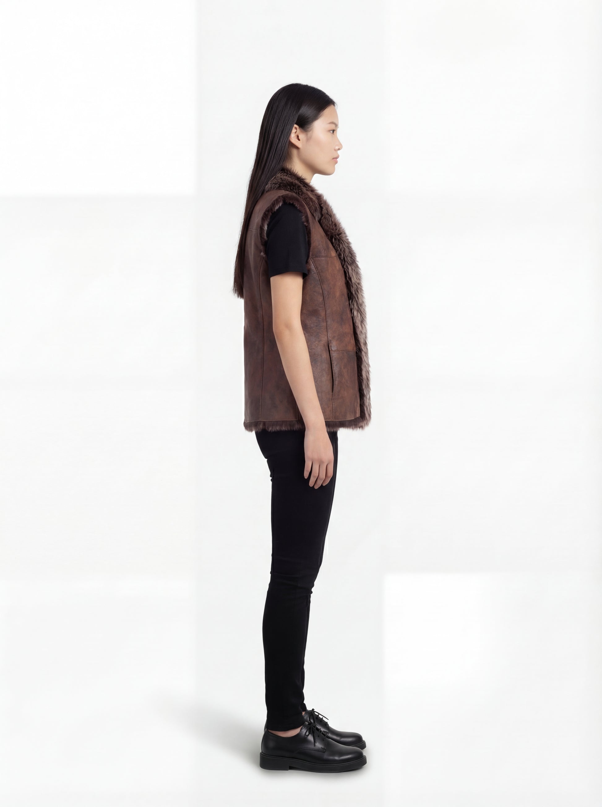 Side profile of Maverick Freya leather vest showing sleeveless armhole cut and straight hip-length silhouette. Maverick Jacket.