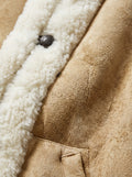 Macro shot of soft tan suede texture and thick cream shearling trim on vest. The Vail by Maverick Jacket.