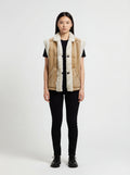Female model wearing Maverick Vail shearling vest, relaxed fit, styled with black skinny jeans and black leather derby shoes. Maverick Jacket.