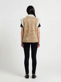 Rear view of female model wearing Maverick Vail shearling vest showing structured shoulder fit and panelled back styling. Maverick Jacket.