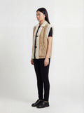 Side profile of Maverick Vail shearling vest showing deep armhole cut and straight hip-length silhouette. Maverick Jacket.