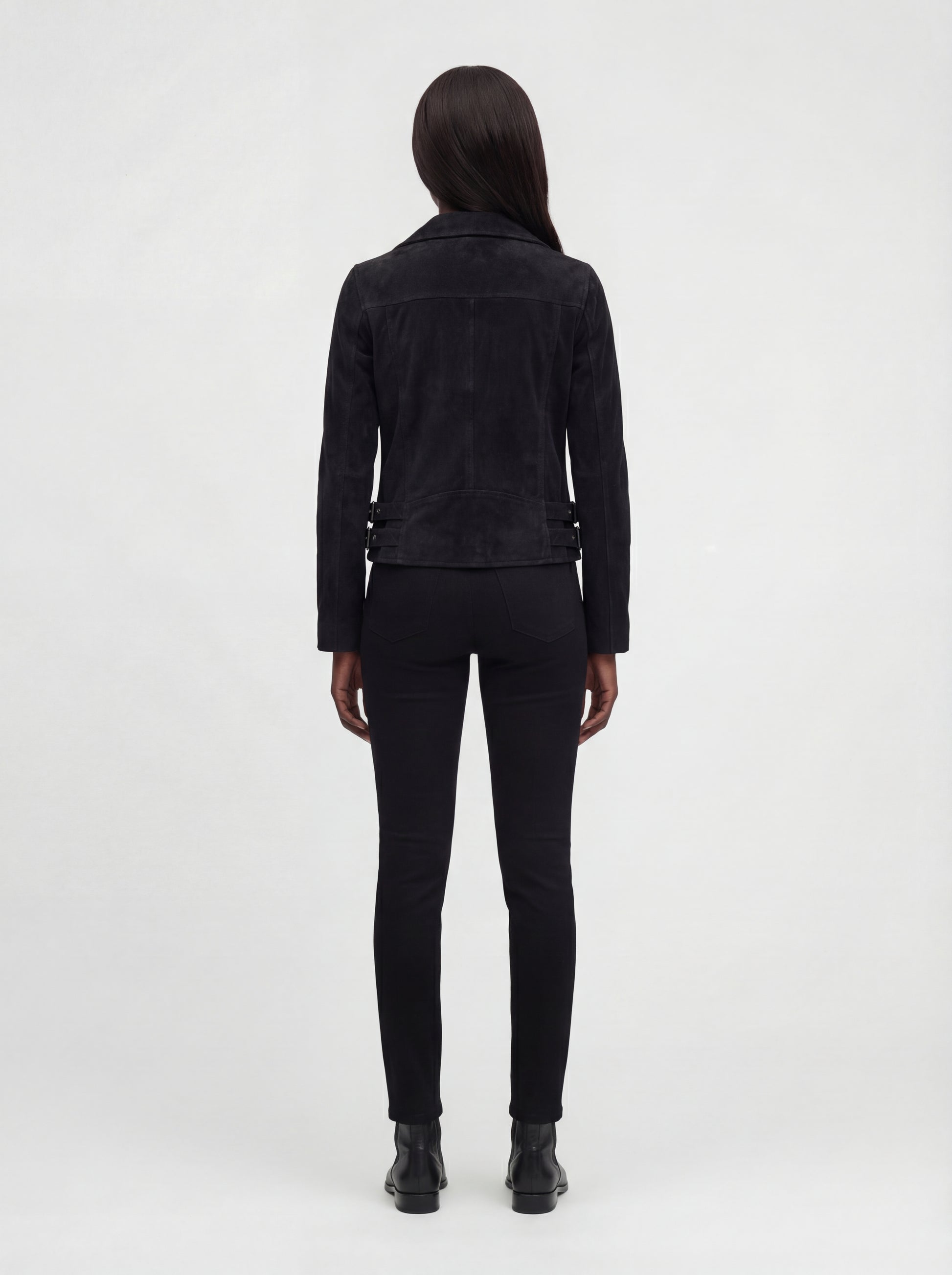 Rear view of female model wearing Maverick Eclipse suede jacket showing structured shoulder fit and fitted back styling. Maverick Jacket.