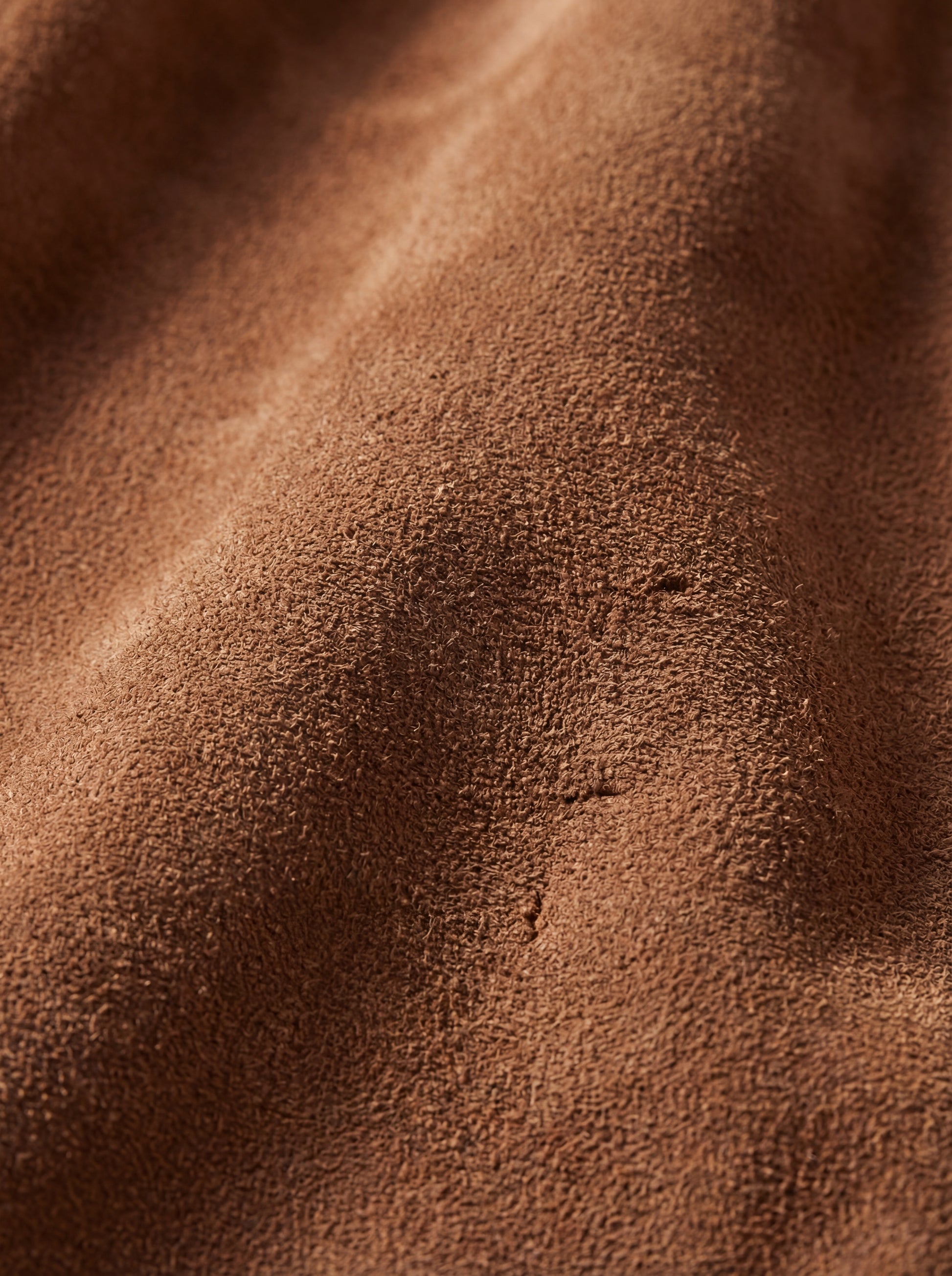 Macro shot of soft tan suede texture and rich fabric nap on jacket. The Montana by Maverick Jacket.